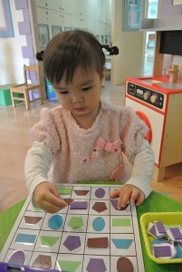 child solving simple puzzle